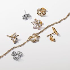 Glittrande stiftörhängen med en evighetssymbol