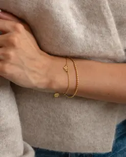 Elegant armband med rosettberlock i guldplätering