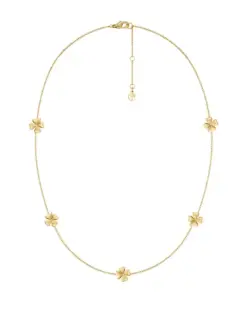 Detaljbild av flerfärgat halsband i guld med små infattade stenar